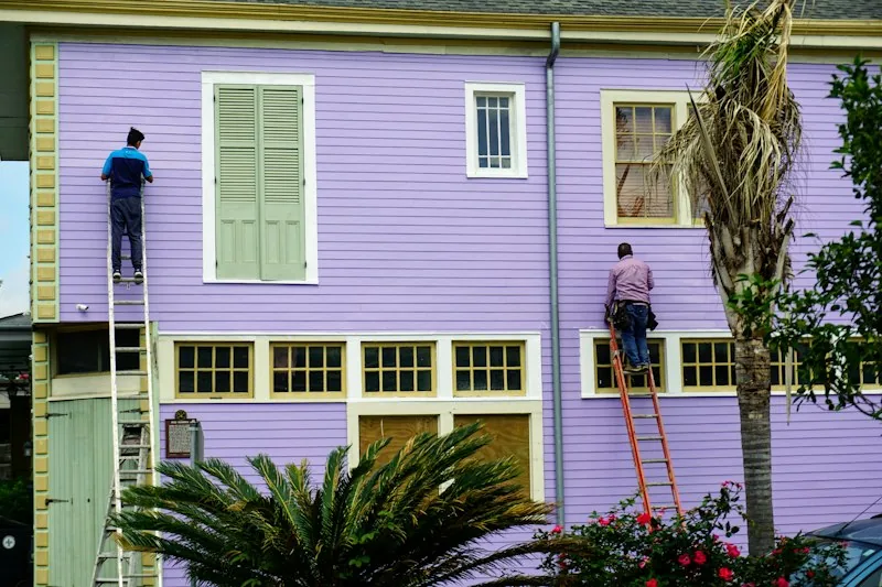 Painters renovating a house facade